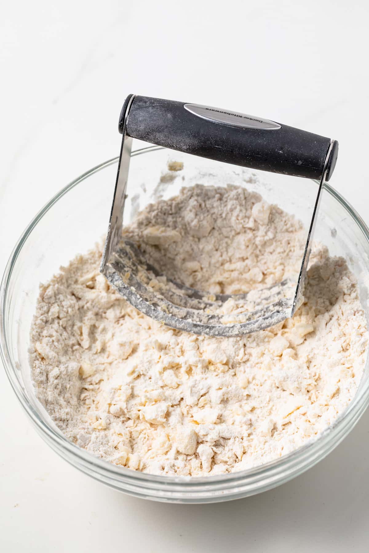 Butter cut into flour with pastry blender.
