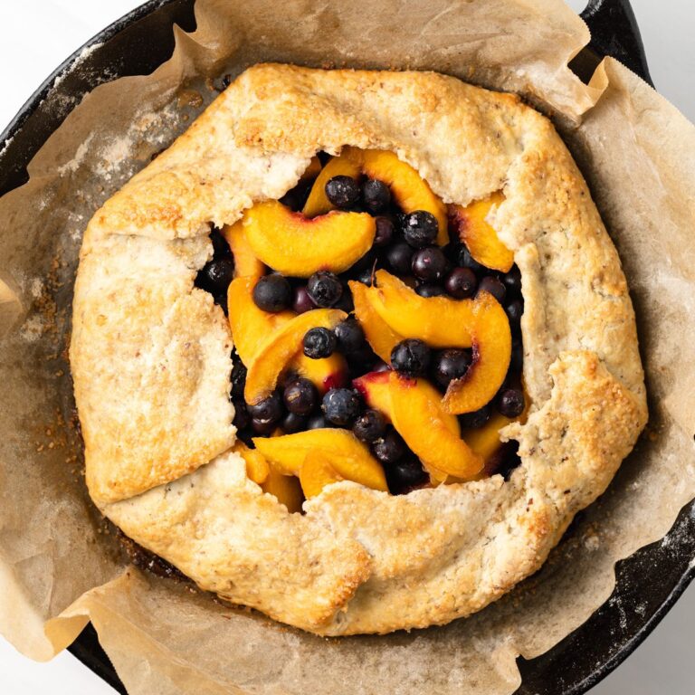 Peach blueberry galette in cast iron skillet.