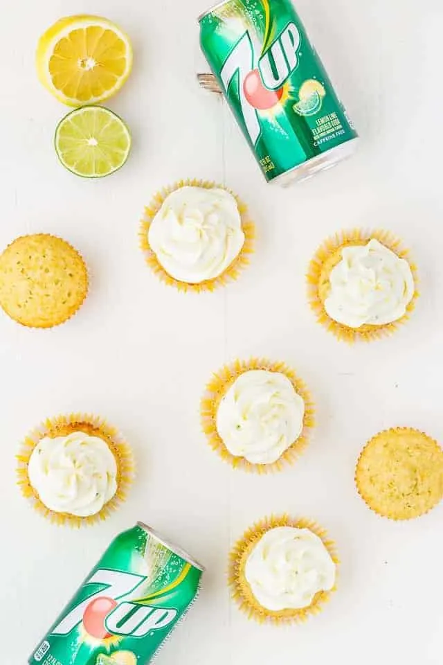 Overhead view of lemon lime cupcakes and cans of 7UP.