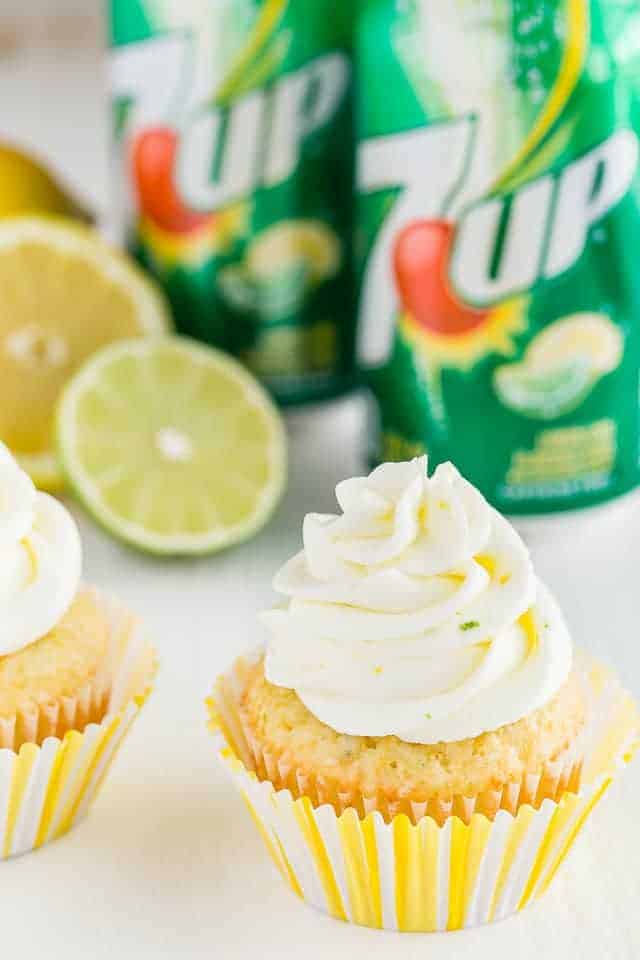 Side view of lemon lime cupcakes with cans of 7up.