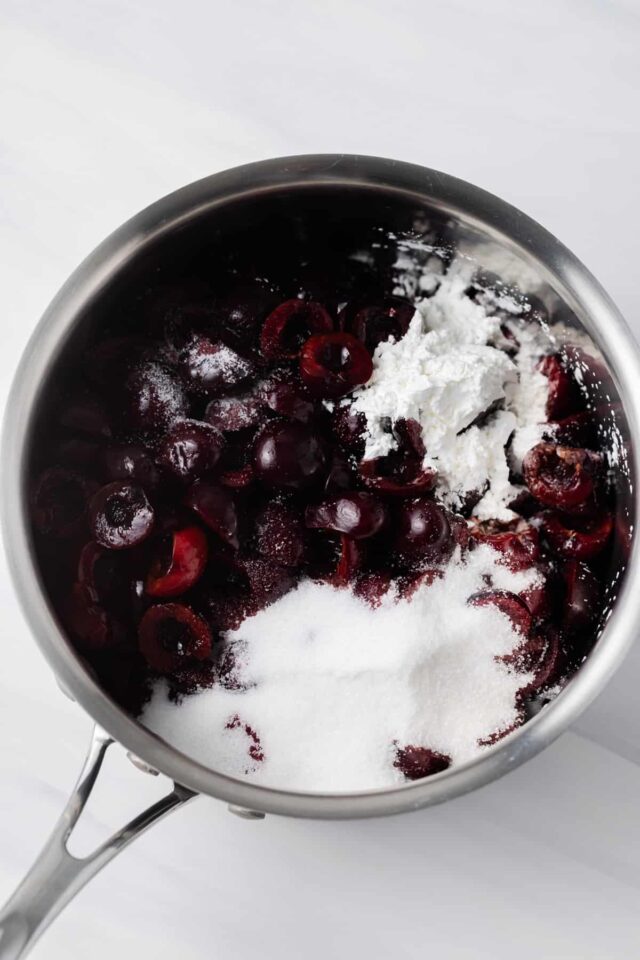 Halves cherries with sugar and cornstarch in a pan