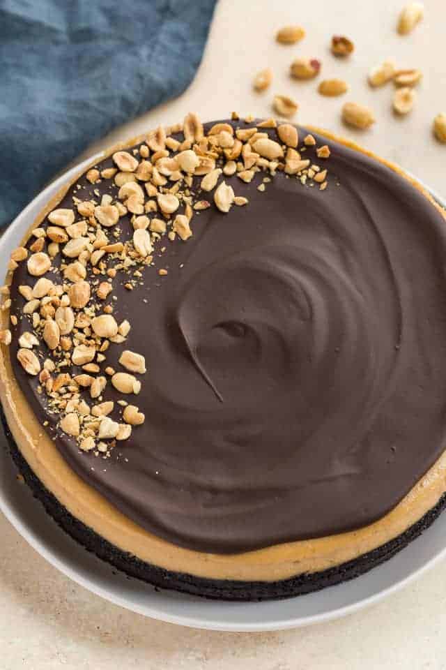High angled view of chocolate peanut butter cheesecake on a white plate.