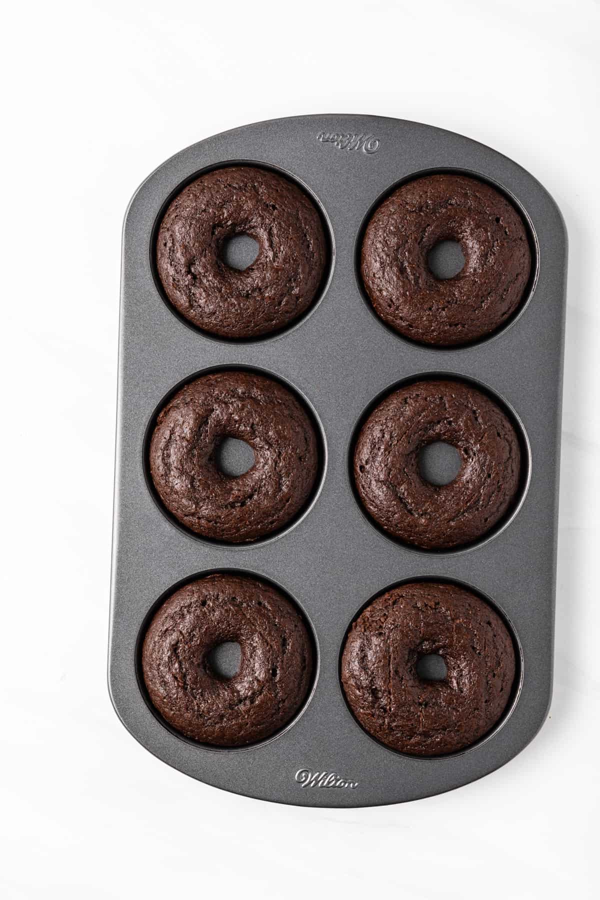 Baked chocolate donuts in a donut pan