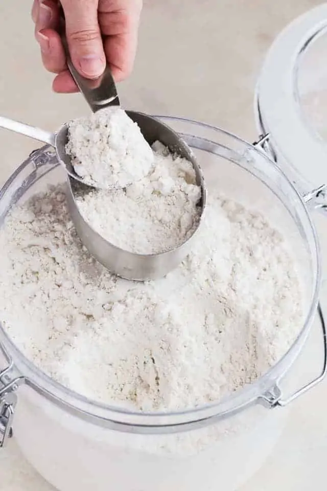 flour being spooned into a measuring cup