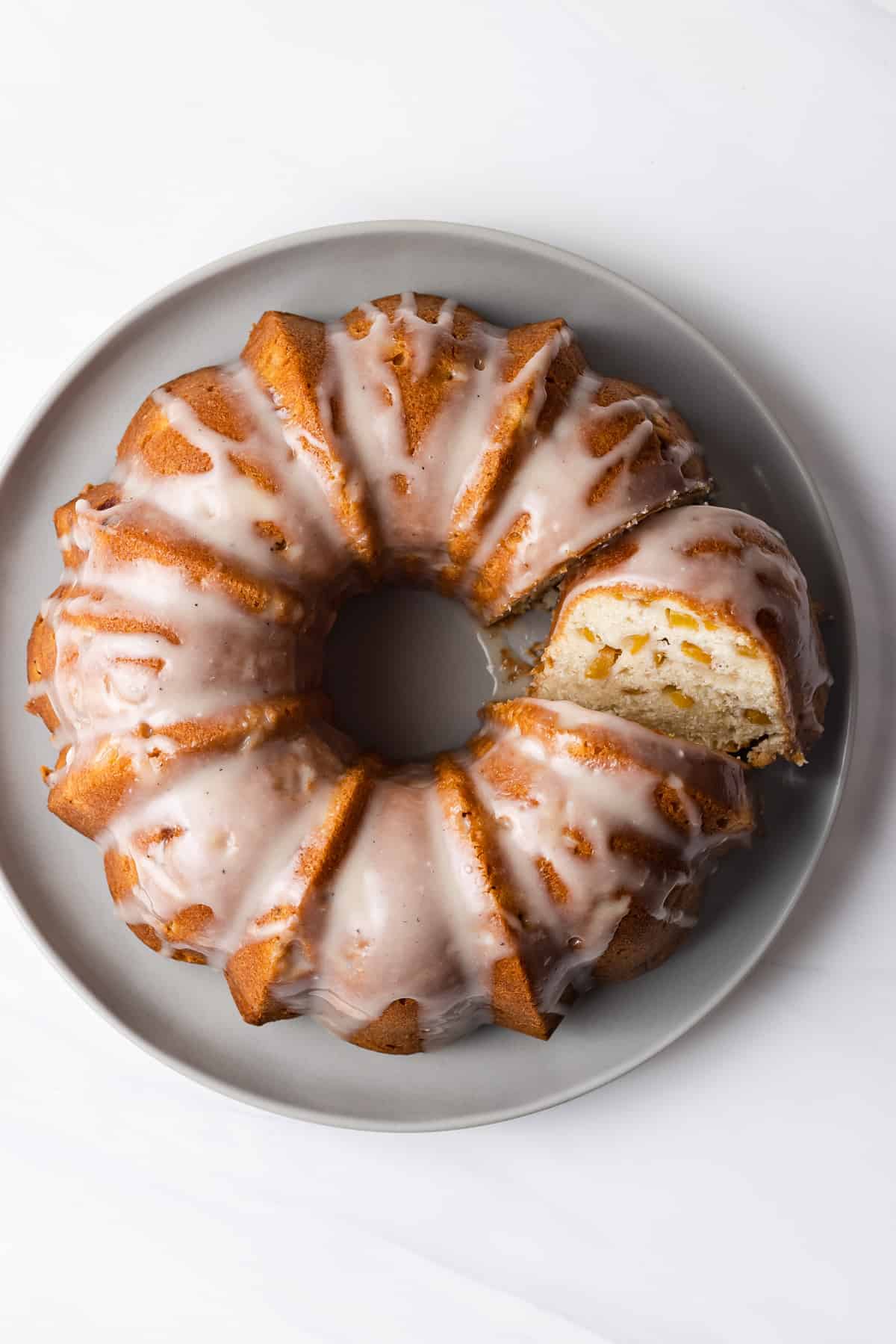 A peach pound cake with glaze over the top
