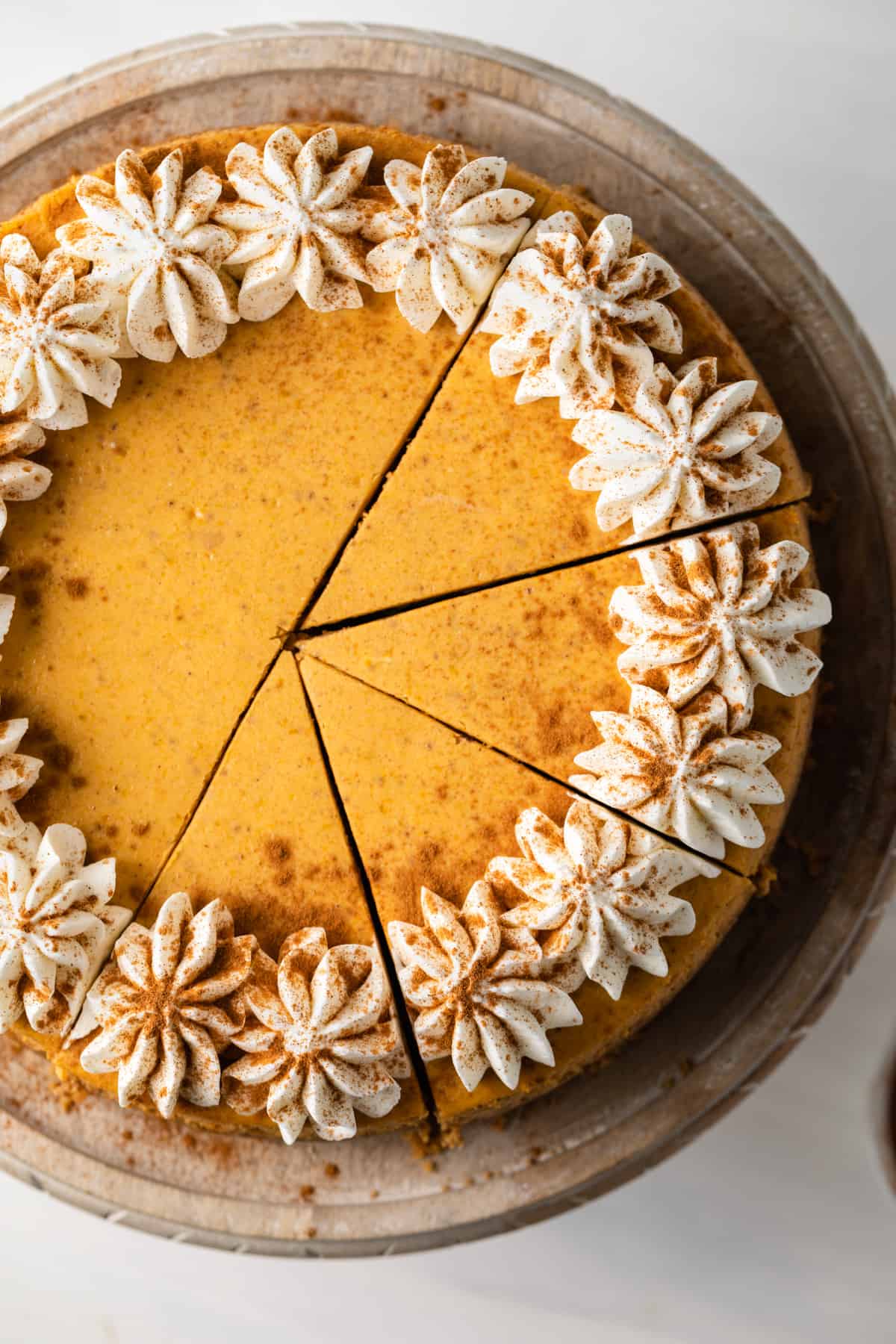 Creamy pumpkin cheesecake topped with homemade whipped cream