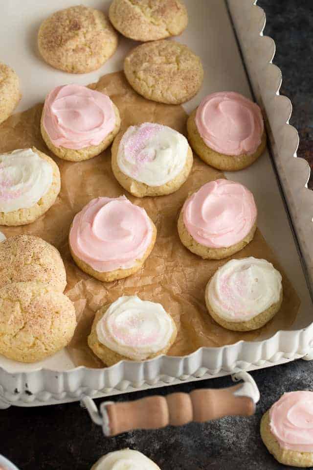 Neatly arrange sour cream cookies in on a white tray.
