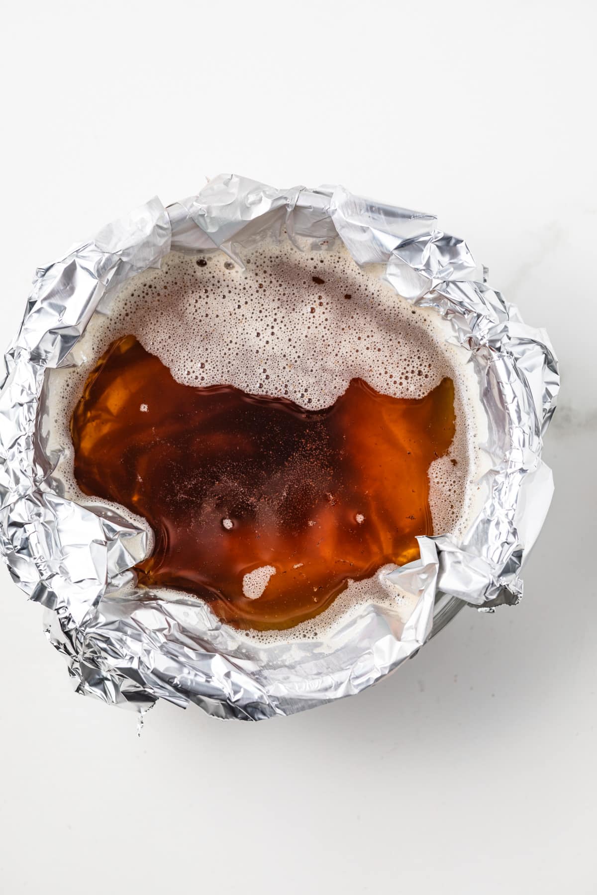 Brown butter in a bowl lined with foil.