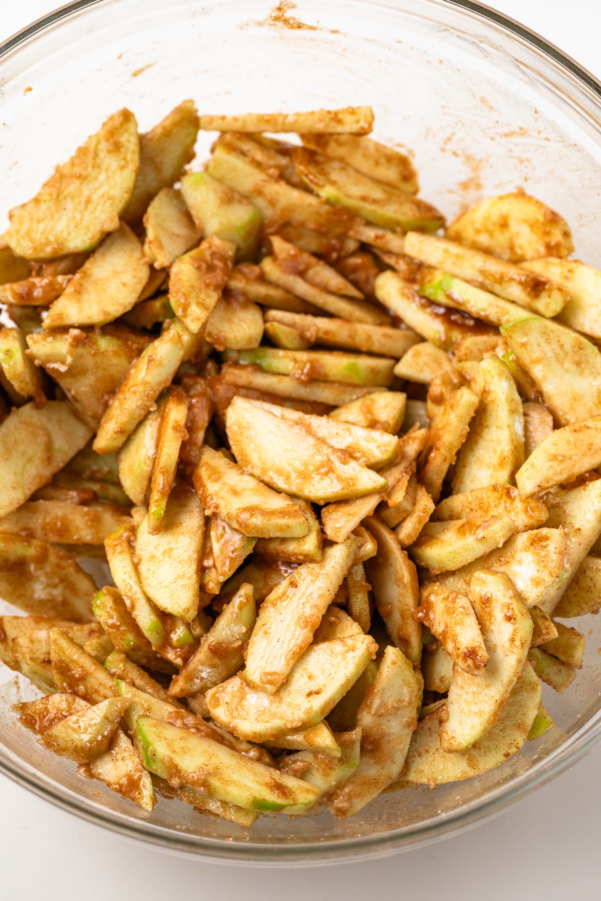 Apple pie filling in a glass bowl.