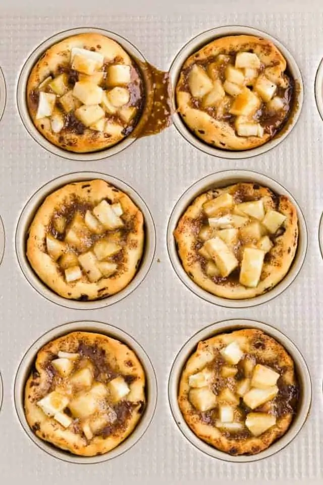 Apple Pie Cinnamon Roll Cups in a gold muffin pan.