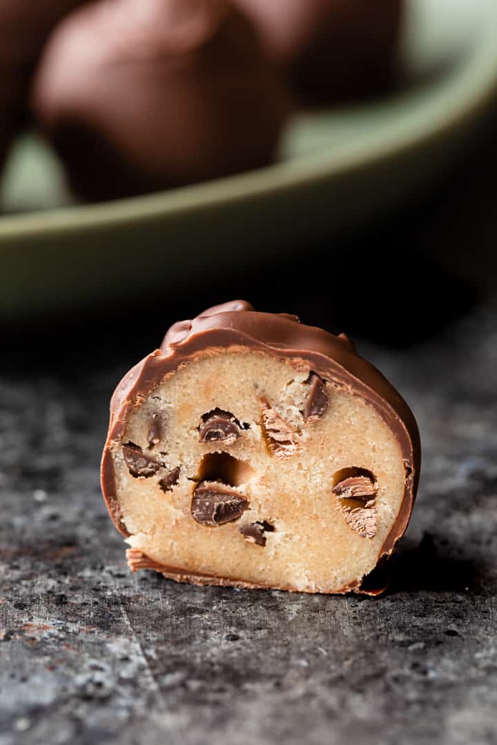 chocolate chip cookie dough truffle cut in half so the inside is visible