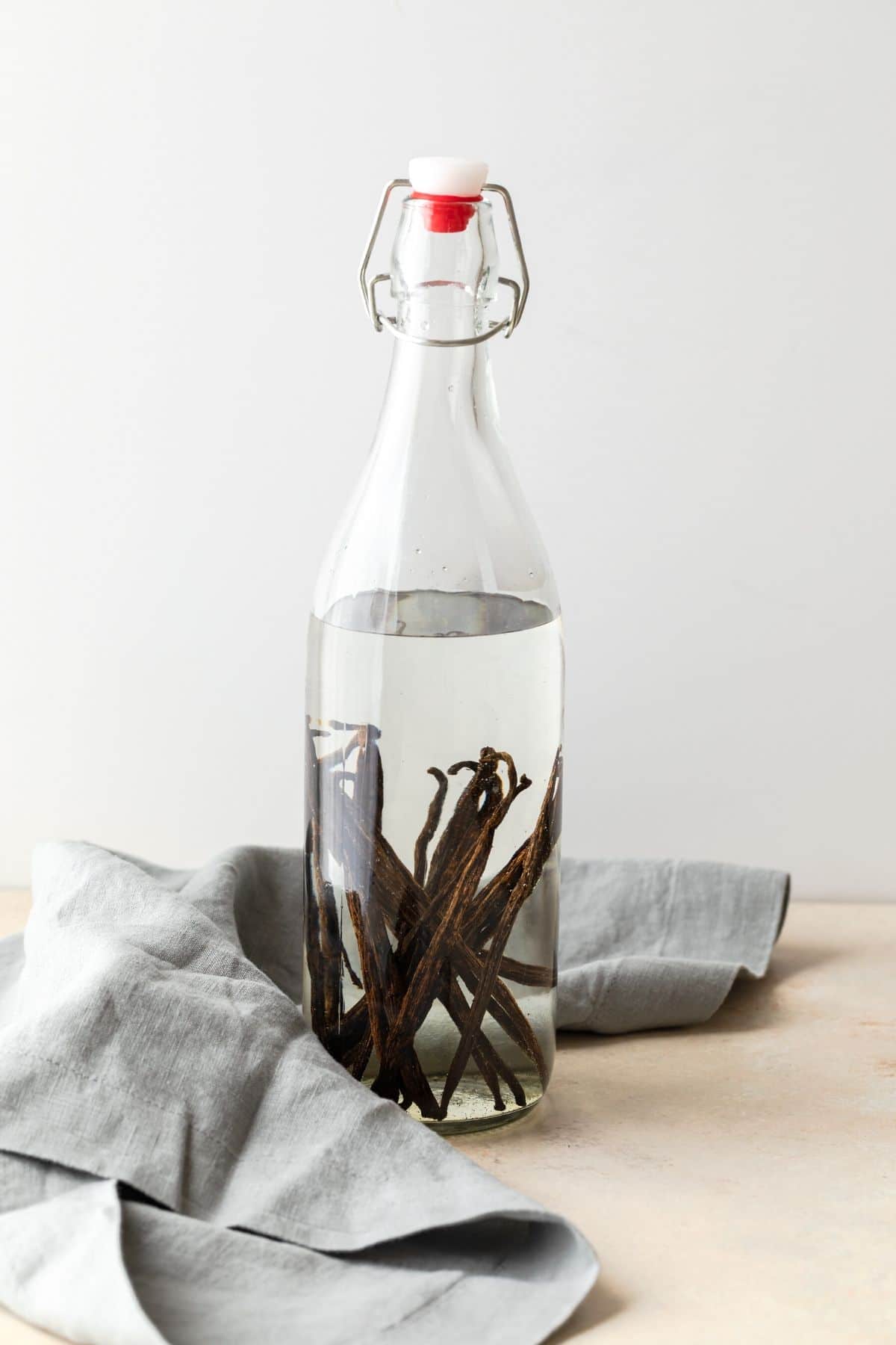 vanilla beans in a clear jar of vodka