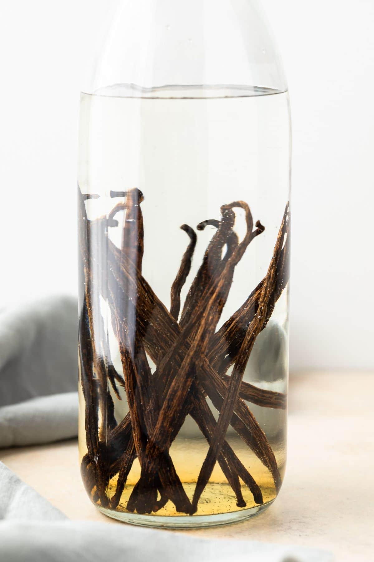 vanilla beans in a clear jar of vodka