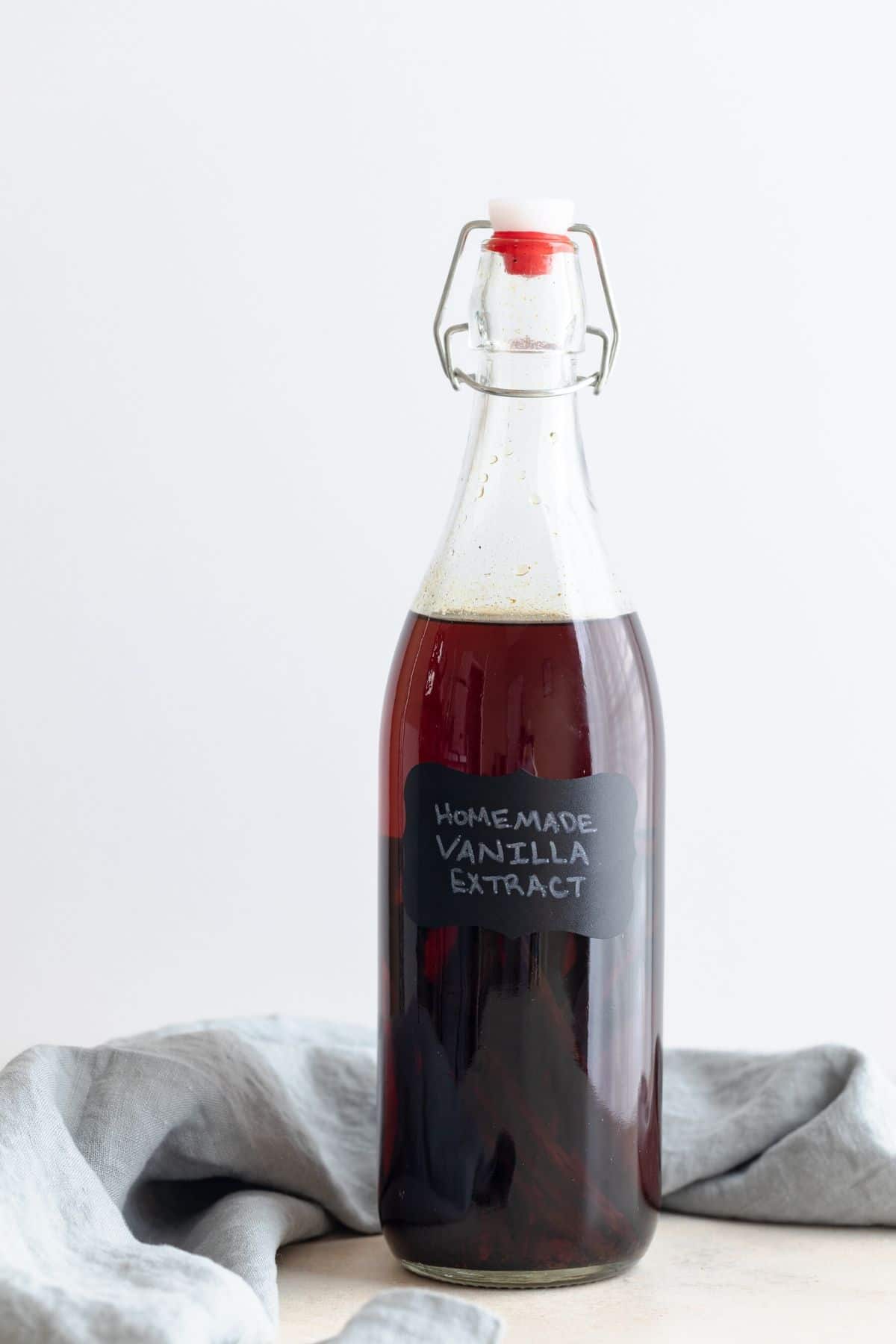 Aged vanilla extract in a clear glass jar