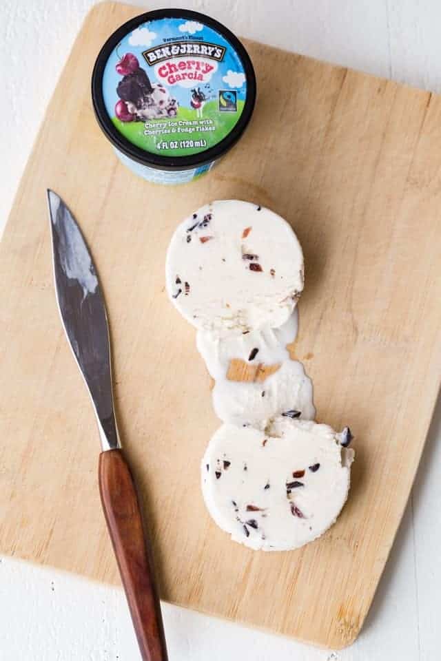 Ben & Jerry's ice cream sliced into two disks on a cutting board.