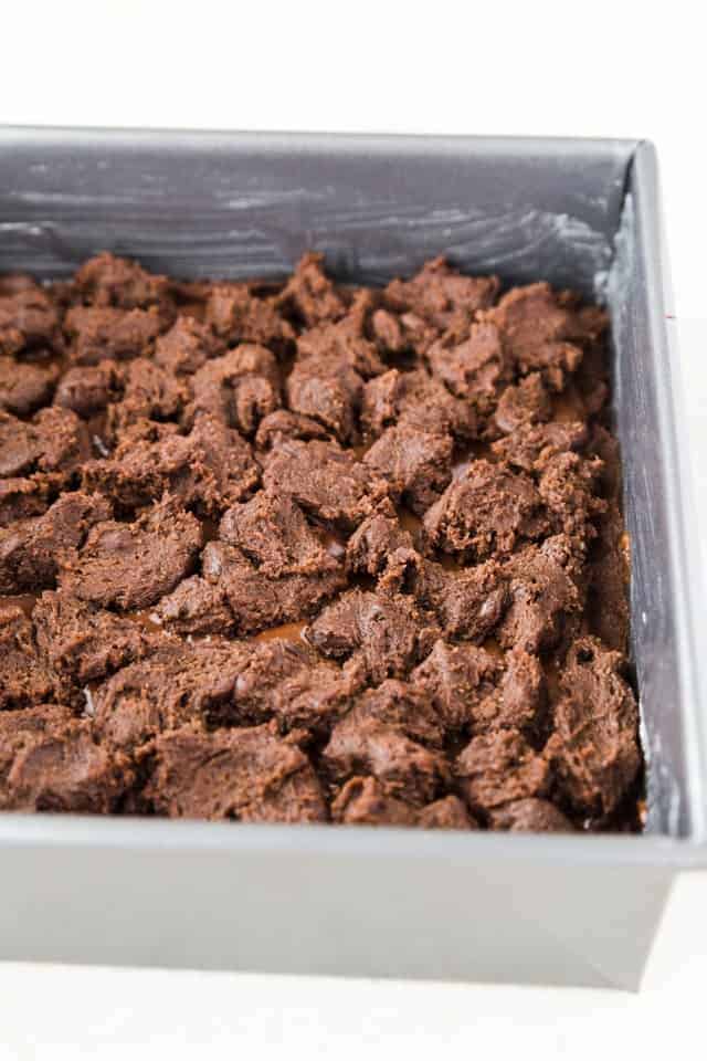 Unbaked chocolate nutella cookie bars in a square baking pan.