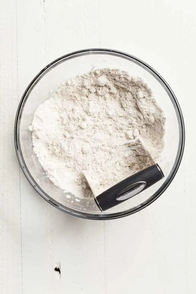 butter cut into flour with pastry cutter in glass bowl