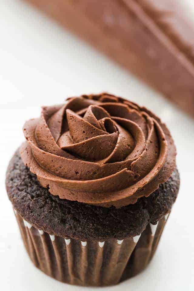 closeup of chocolate buttercream frosting swirled on chocolate cupcake