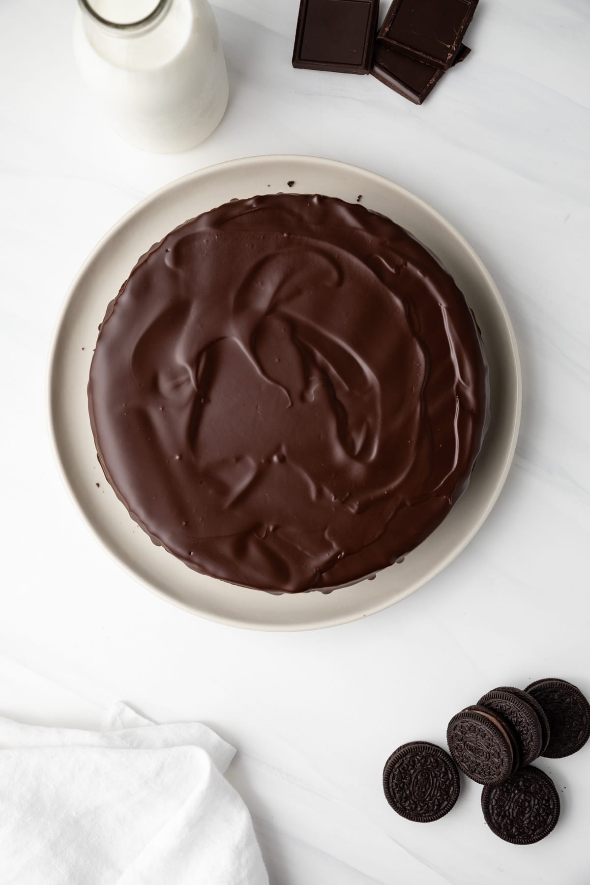 Overhead view of triple chocolate cheesecake on plate.