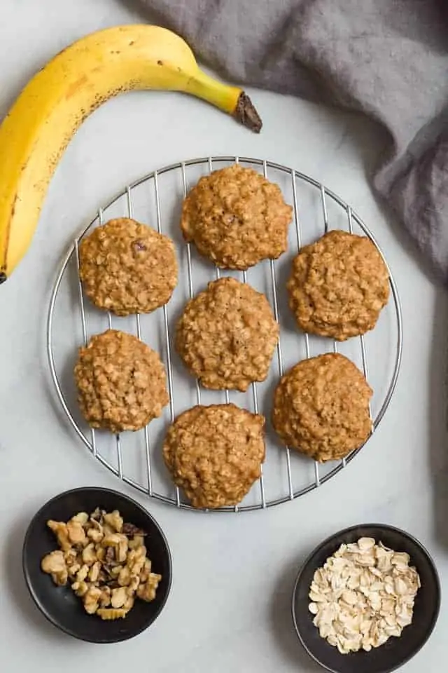 Overhead view of banana cookies with oats on a wire rack.