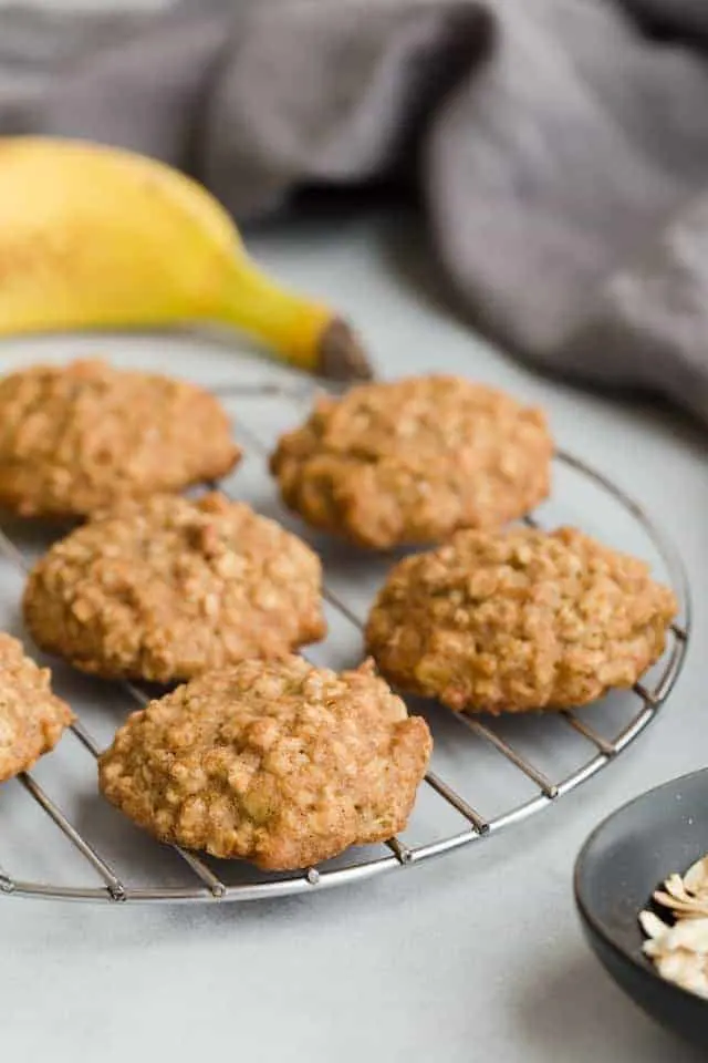 banana oatmeal cookies on a round wire cooling rack.