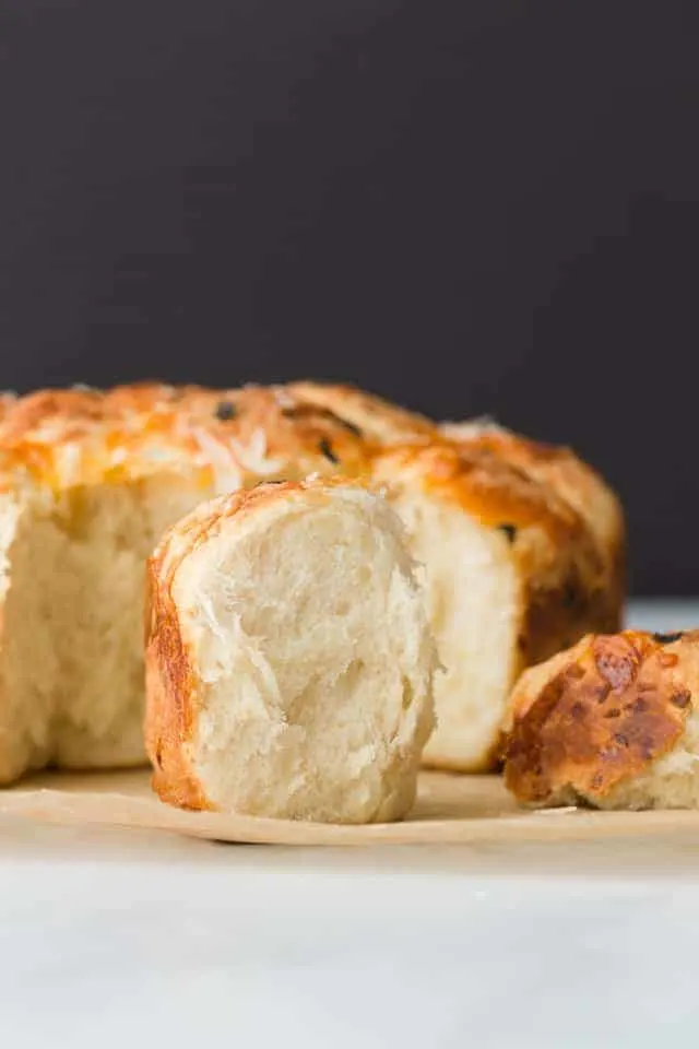 Side view of a fluffy Cheesy Pull Apart Roll with Garlic