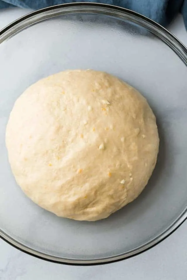 yeast dough in glass bowl