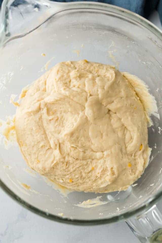 yeast dough with cheese in a glass bowl