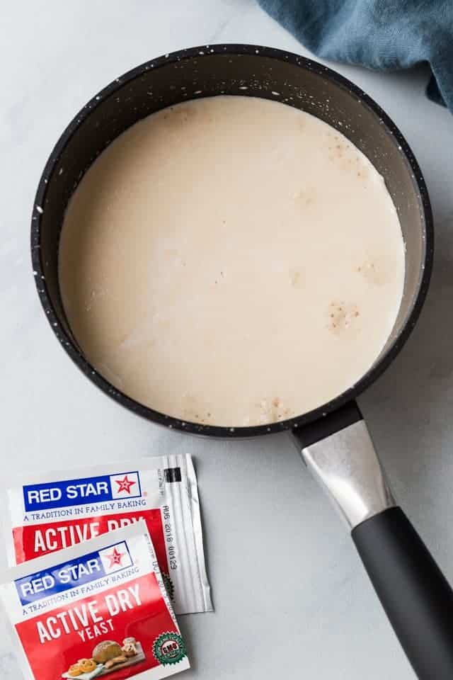 yeast proofing in milk in black saucepan