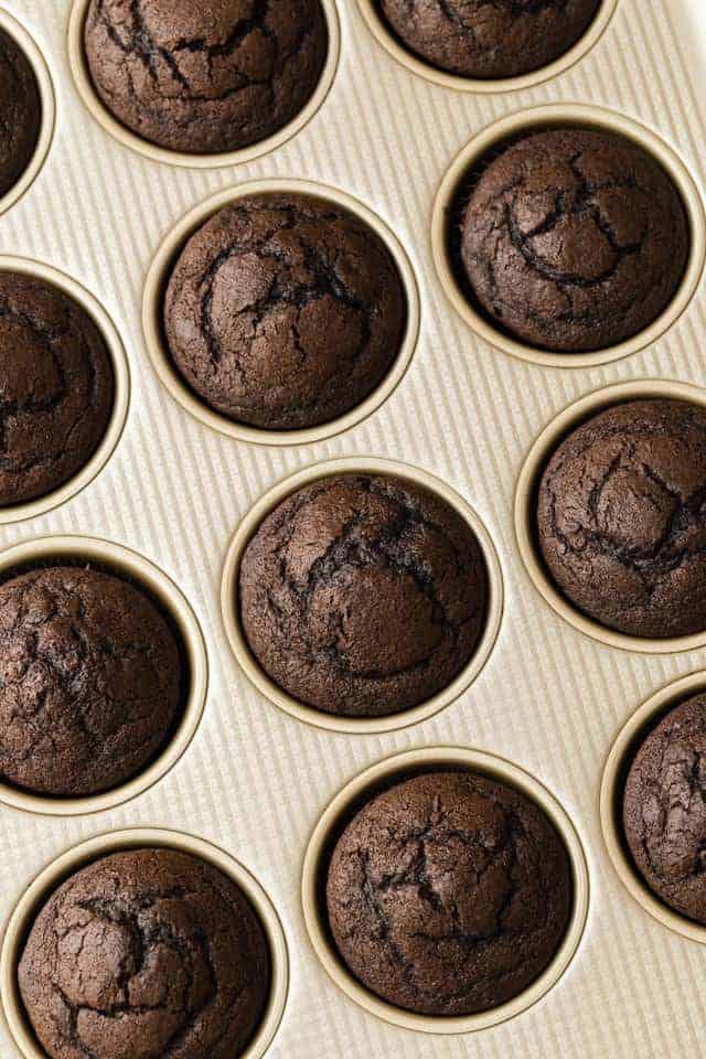 overhead of baked chocolate cupcakes in muffin pan