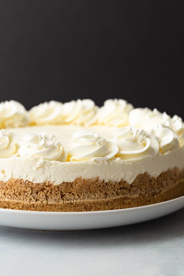 side view of no bake cheesecake on a white serving plate