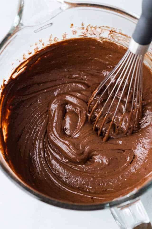 chocolate cupcake batter in glass bowl with whisk