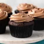 Best Chocolate Cupcakes on a marble cake stand.