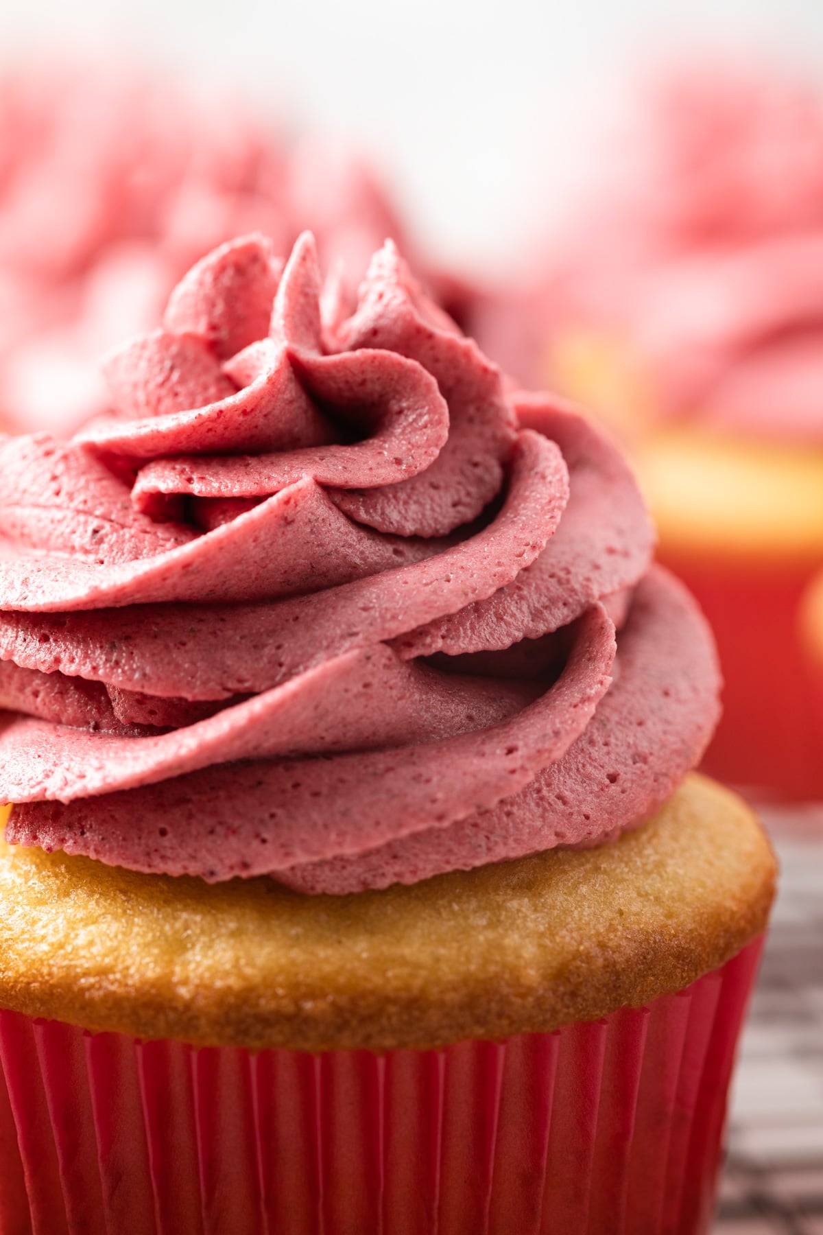 Close up raspberry frosting on a cupcake.