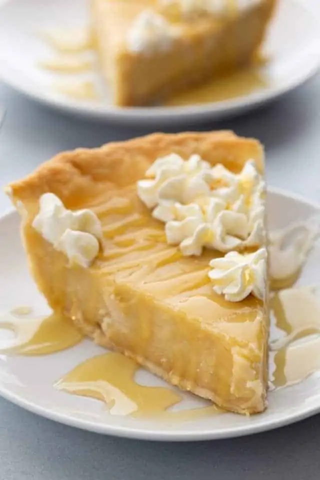 side view of a slice of honey pie on a white plate