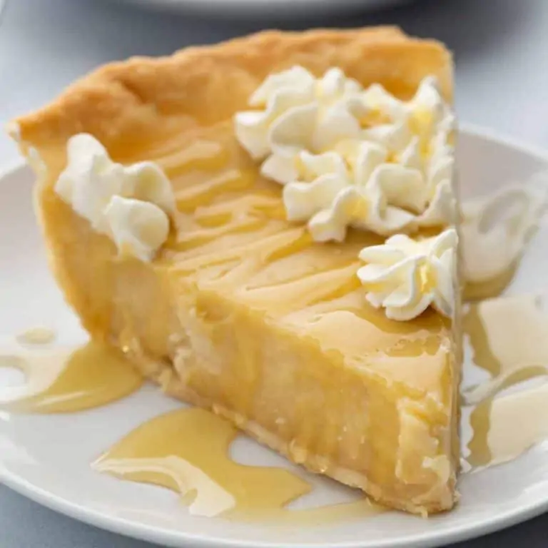side view of a slice of honey pie on a white plate
