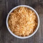 microwave toasted coconut in a white bowl
