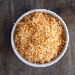 microwave toasted coconut in a white bowl