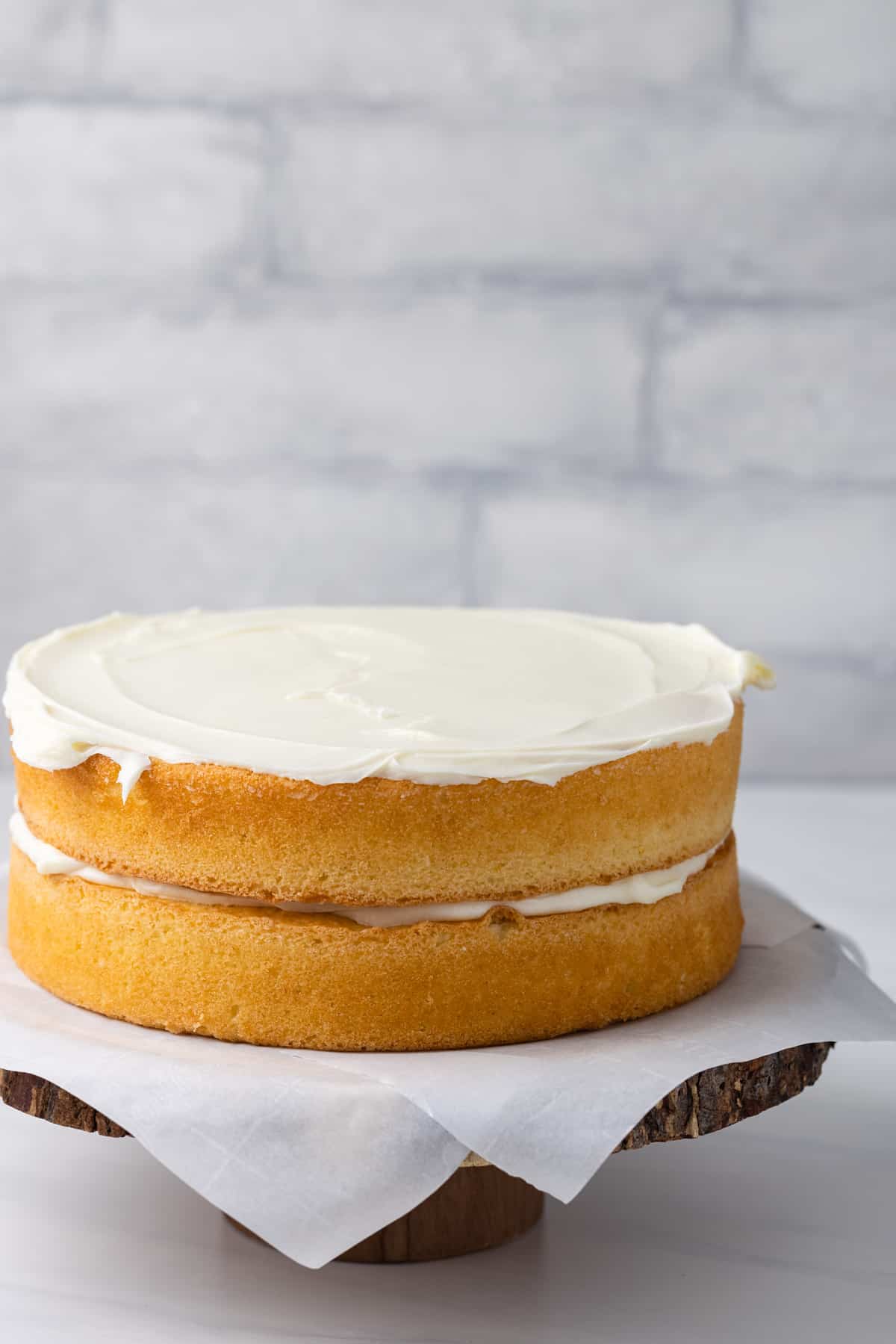 Two lemon cakes with lemon frosting between them