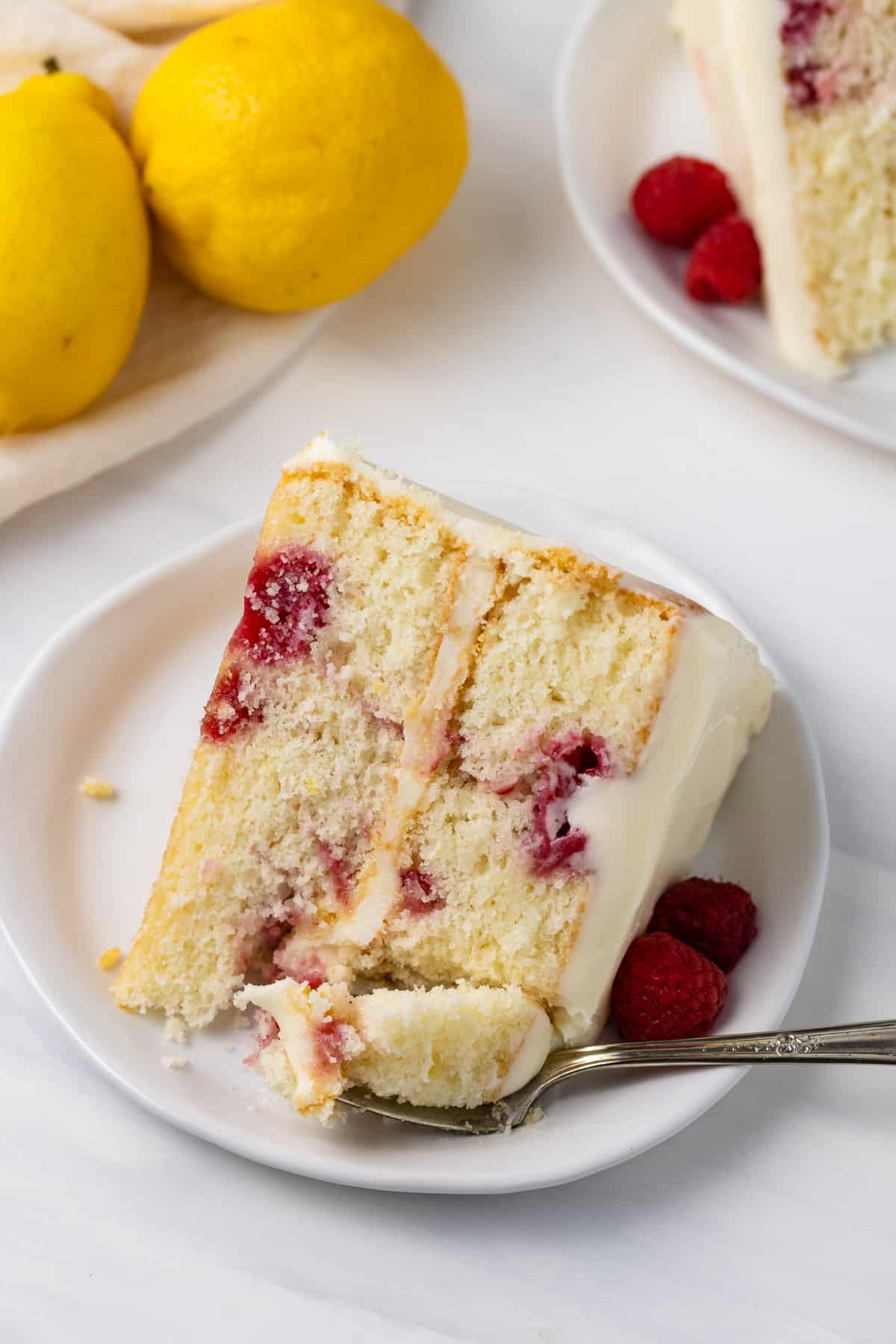 A slice of lemon raspberry cake on a plate