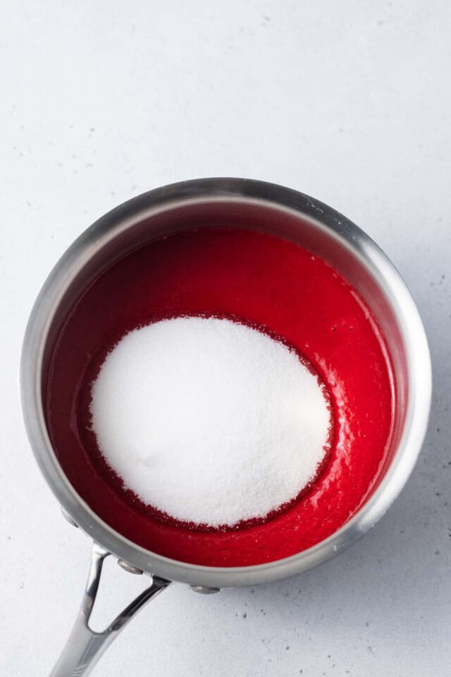 Sugar and raspberry puree in a sauce pan