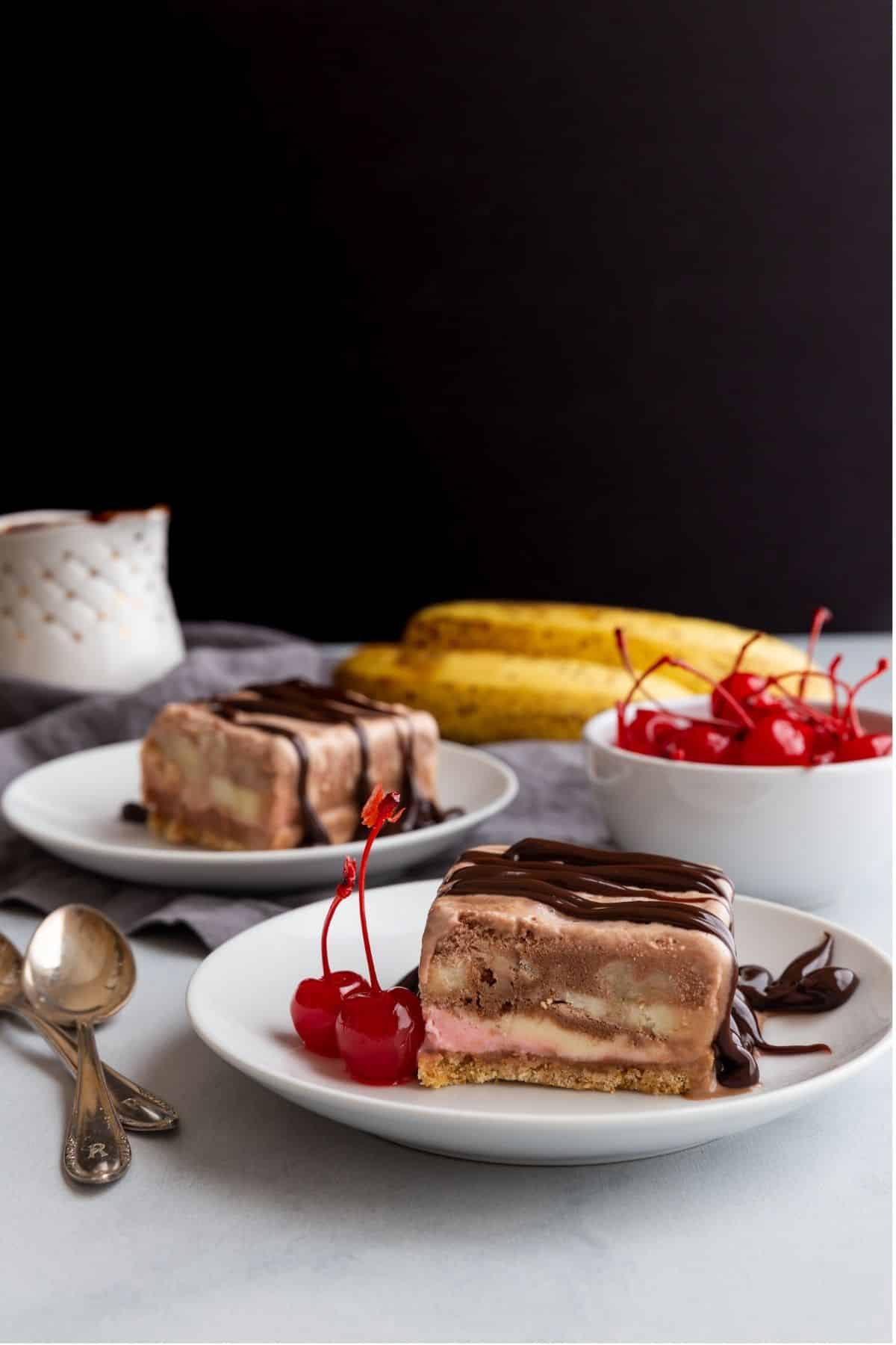 Side view of slices of banana split icebox cake on plates.
