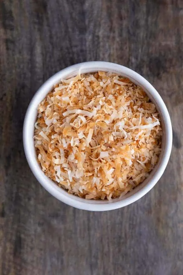 microwave toasted coconut in a white bowl