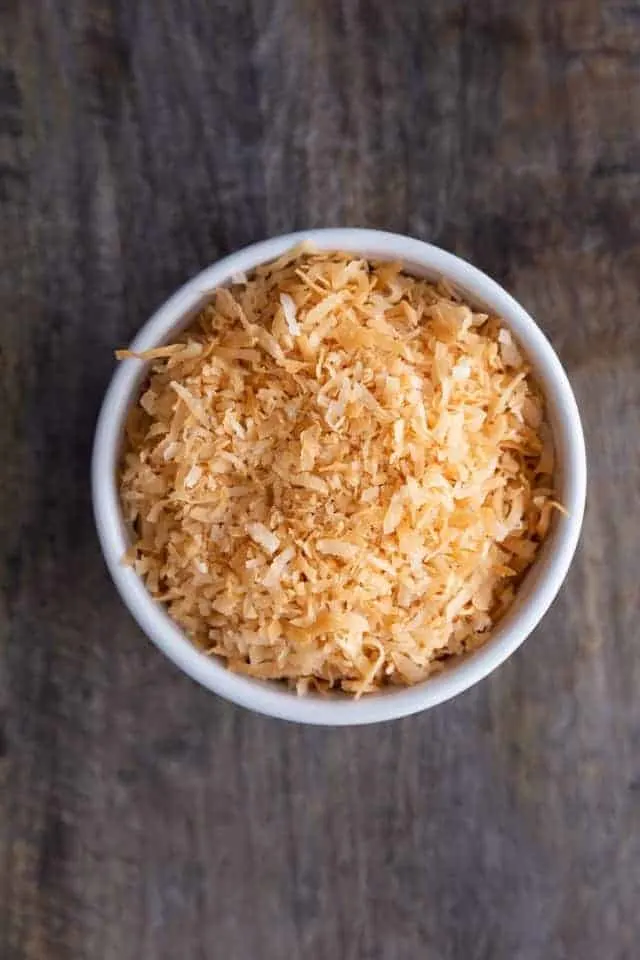 oven toasted coconut in a white bowl