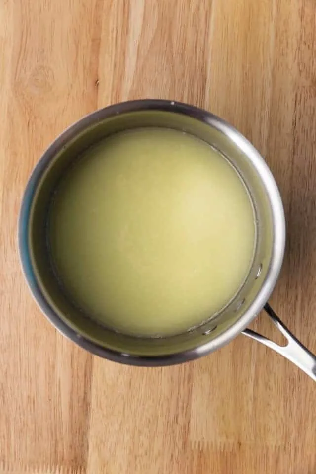 Overhead view of melted butter, sugar, and milk in a saucepan