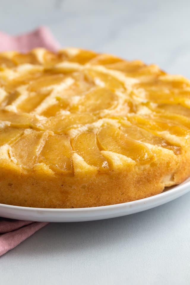 side view of apple cake on a white plate