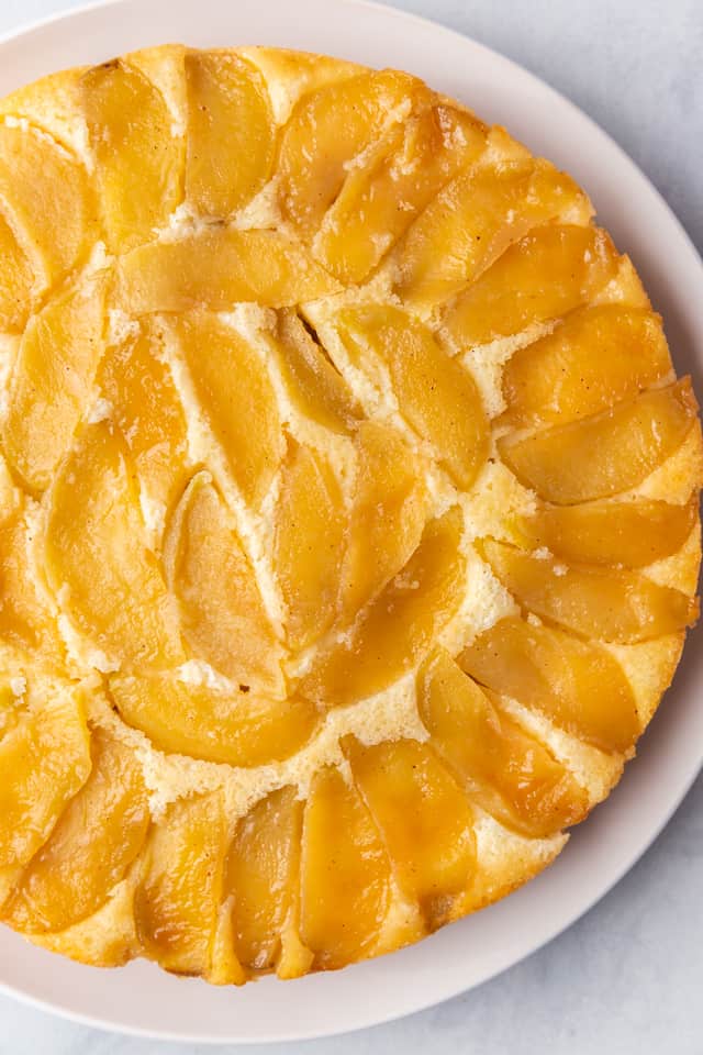 overhead view of apple cake on a white plate