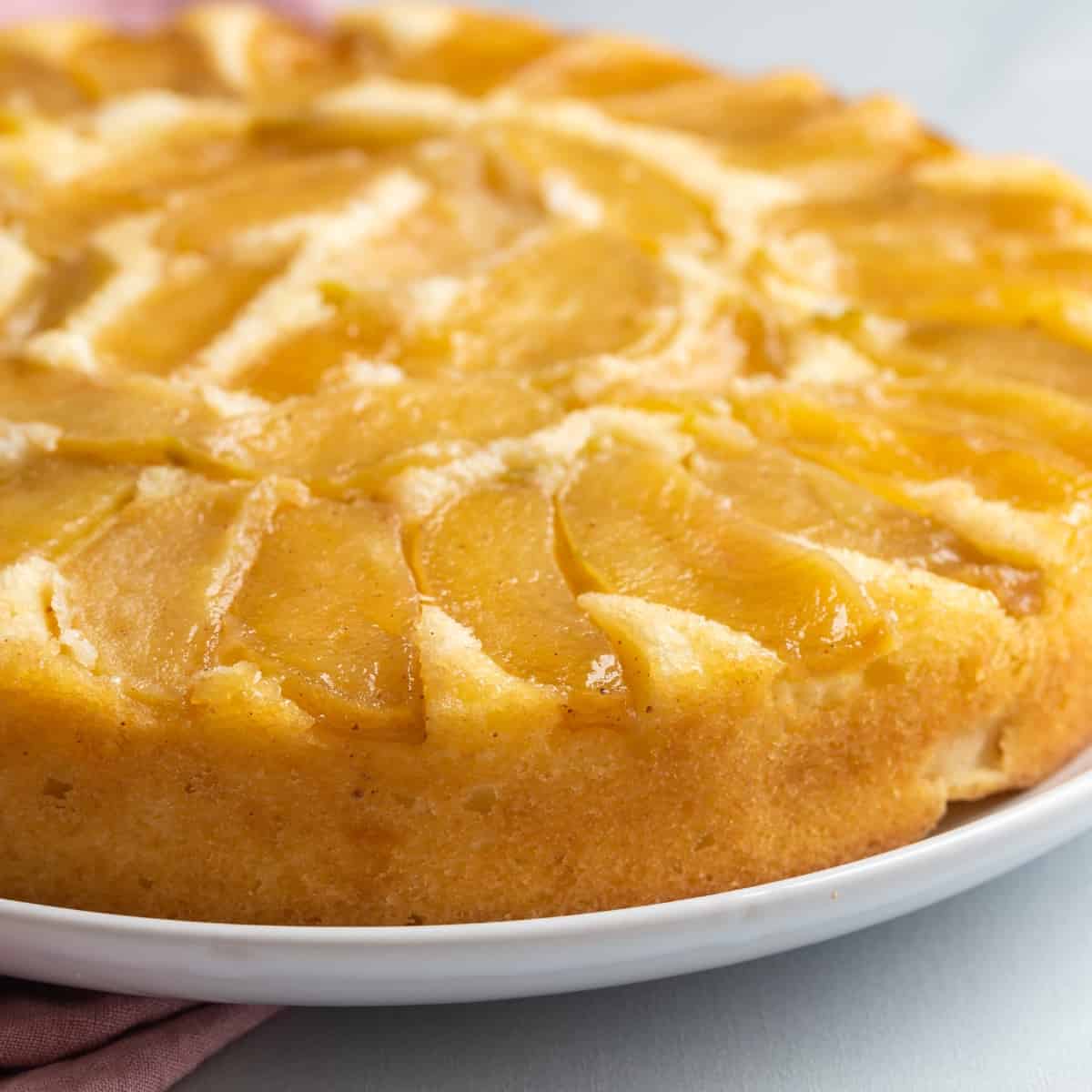Apple cake made with bits of chopped apple throughout and topped with slice...