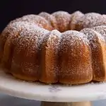 side view of sour cream pound cake on a cake stand