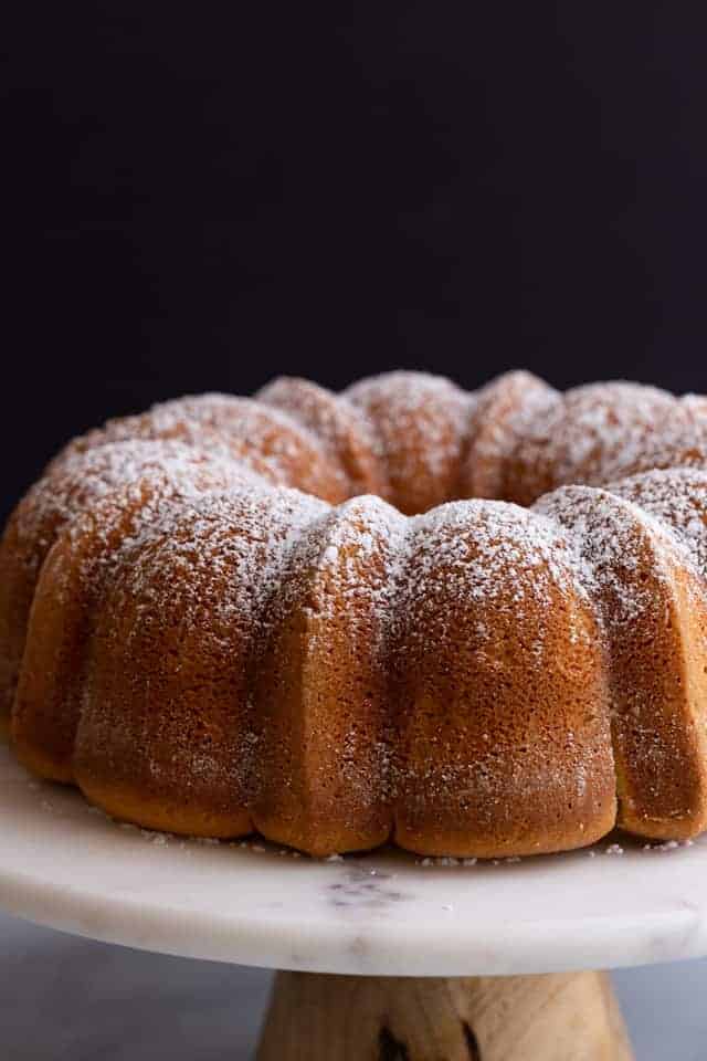 side view of sour cream pound cake on a cake stand